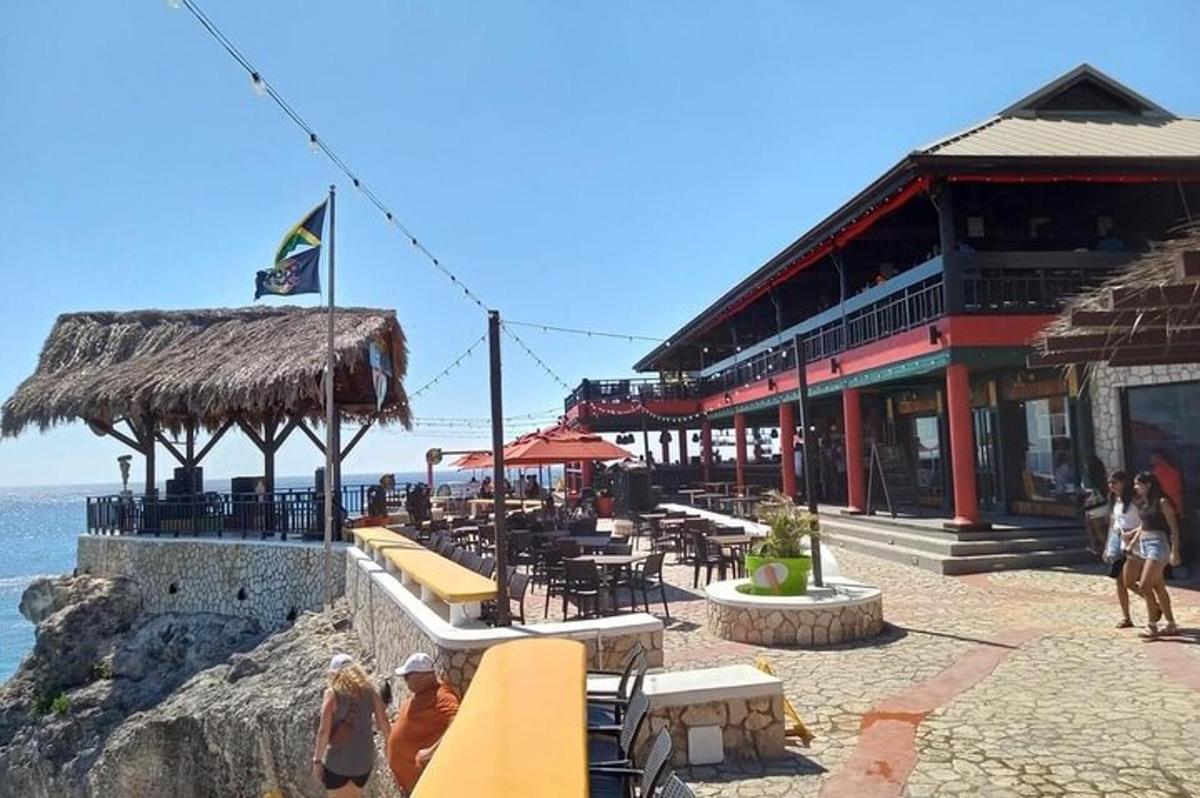 um restaurante na praia com mesas e cadeiras