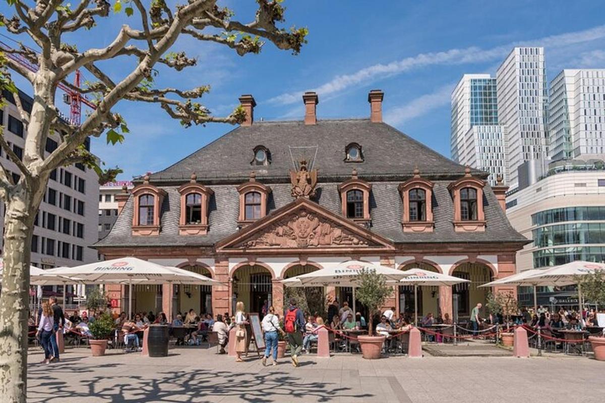 a large brick building with people sitting outside of it