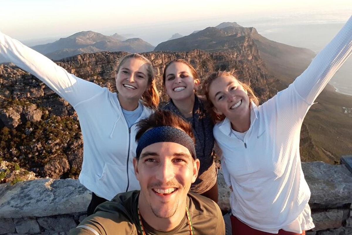a group of people standing at the top of a mountain