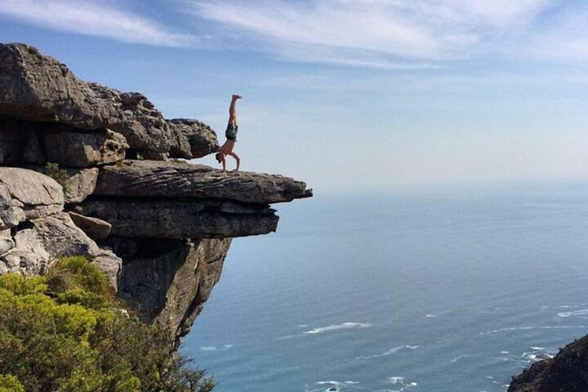 a woman standing on top of a cliff
