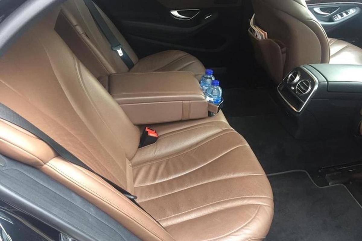 a back seat of a car with a bottle of water