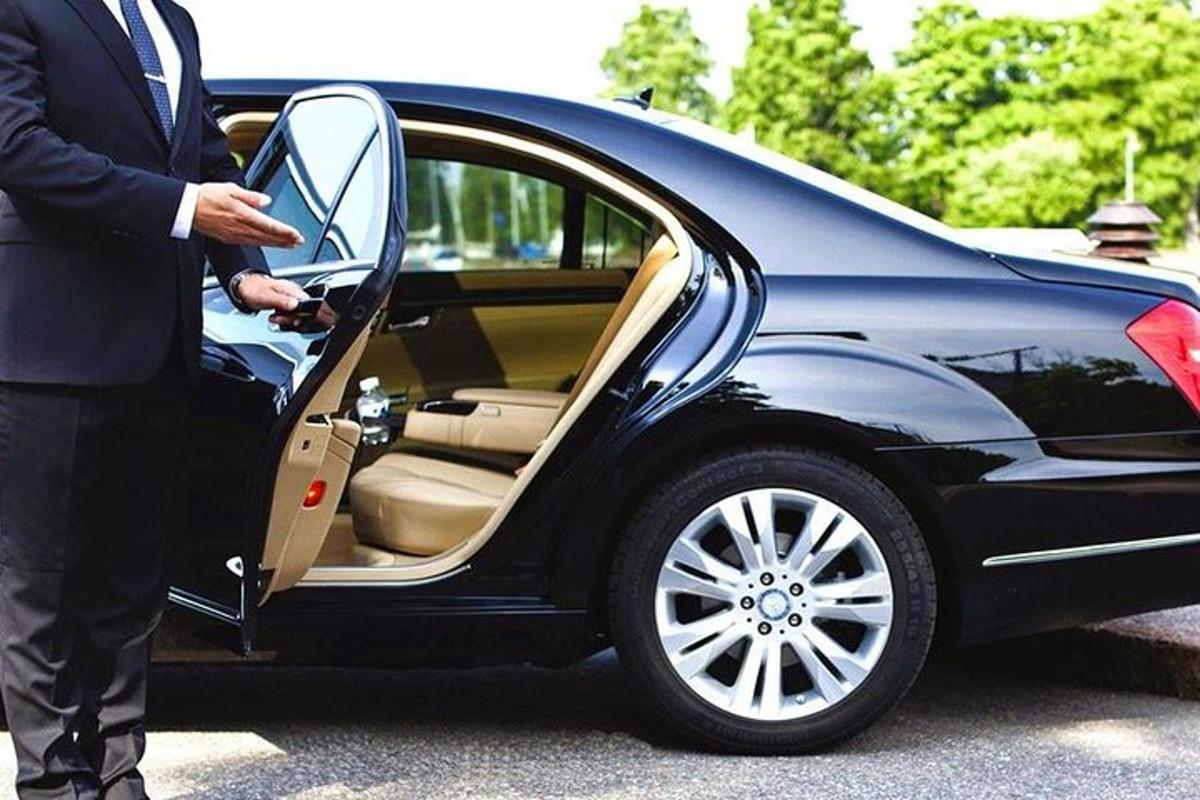 a man in a suit getting into a car