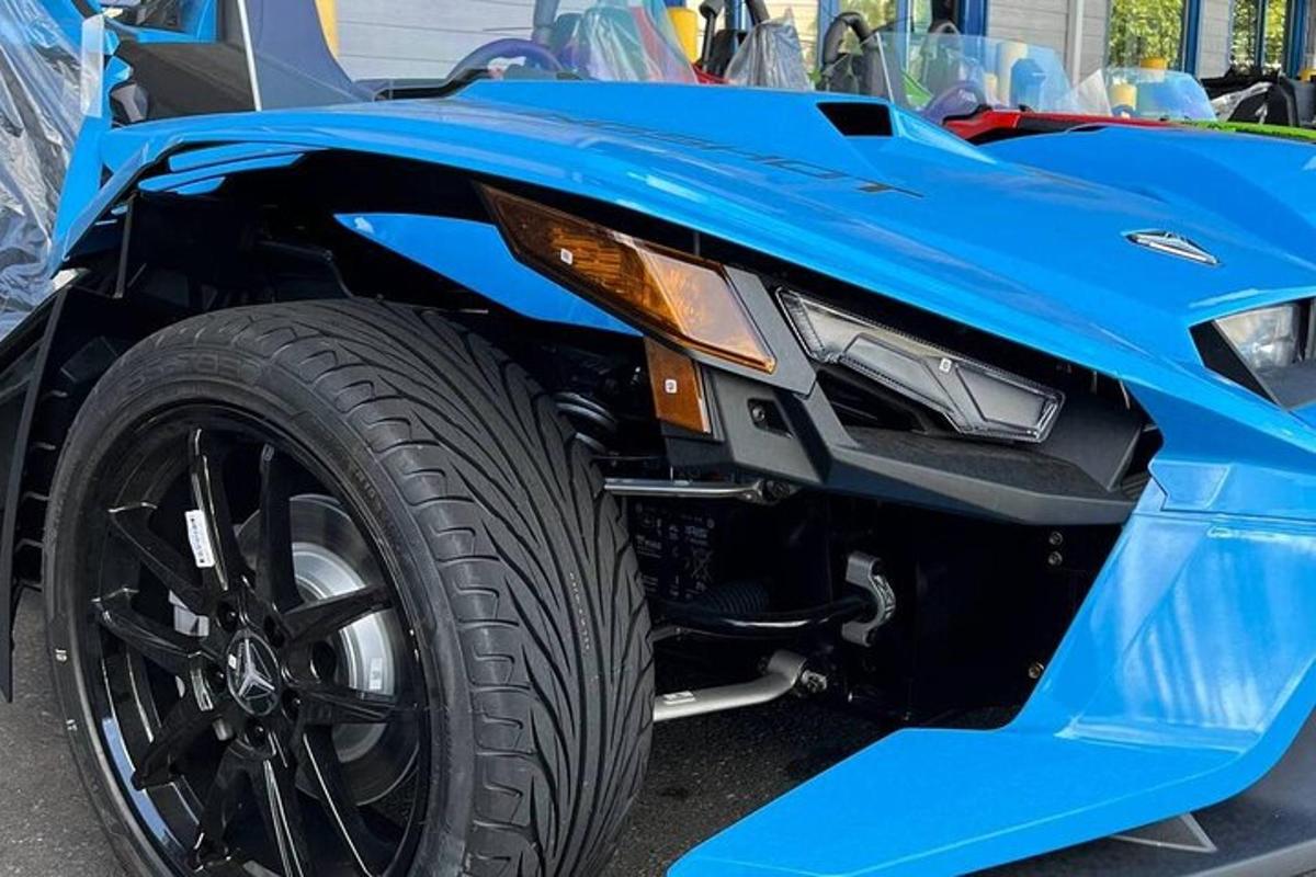 a close up of the front end of a blue car