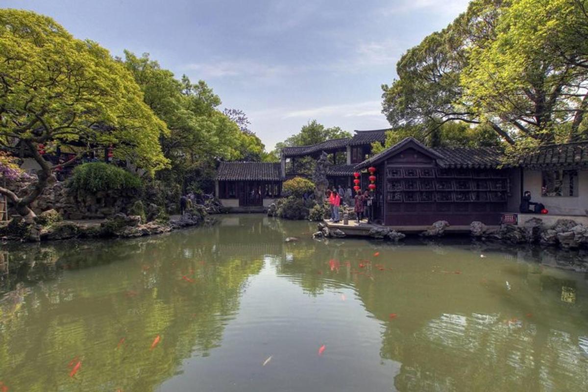a pond in a garden with kites in the water