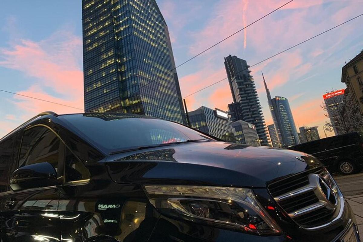 a black car parked in front of a city