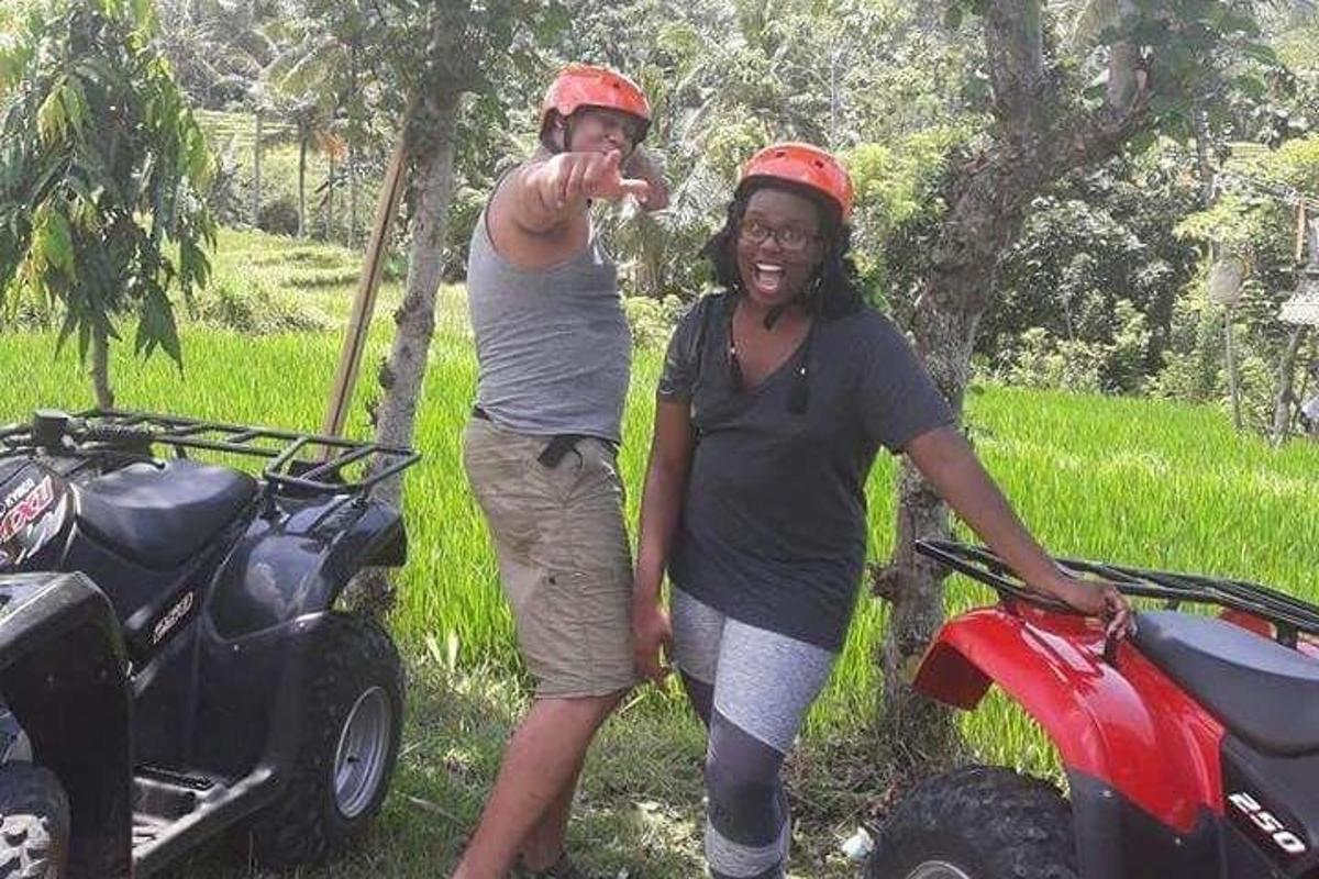 un uomo e una donna in piedi accanto a un quad