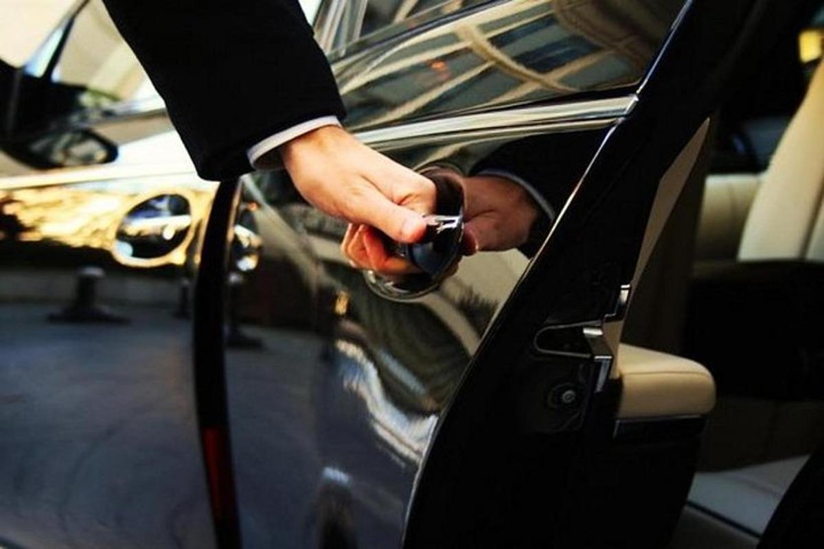 a person is opening the door of a car