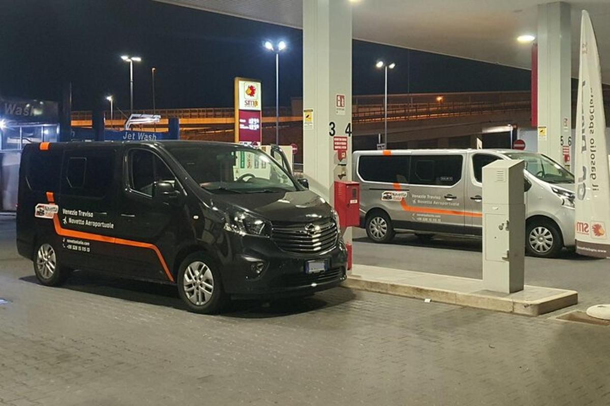 a black van parked at a gas station at night