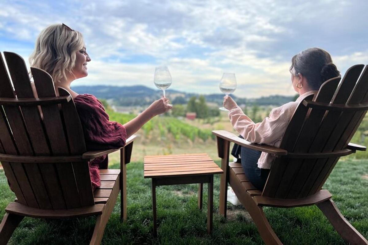 two women sitting in rocking chairs holding wine glasses