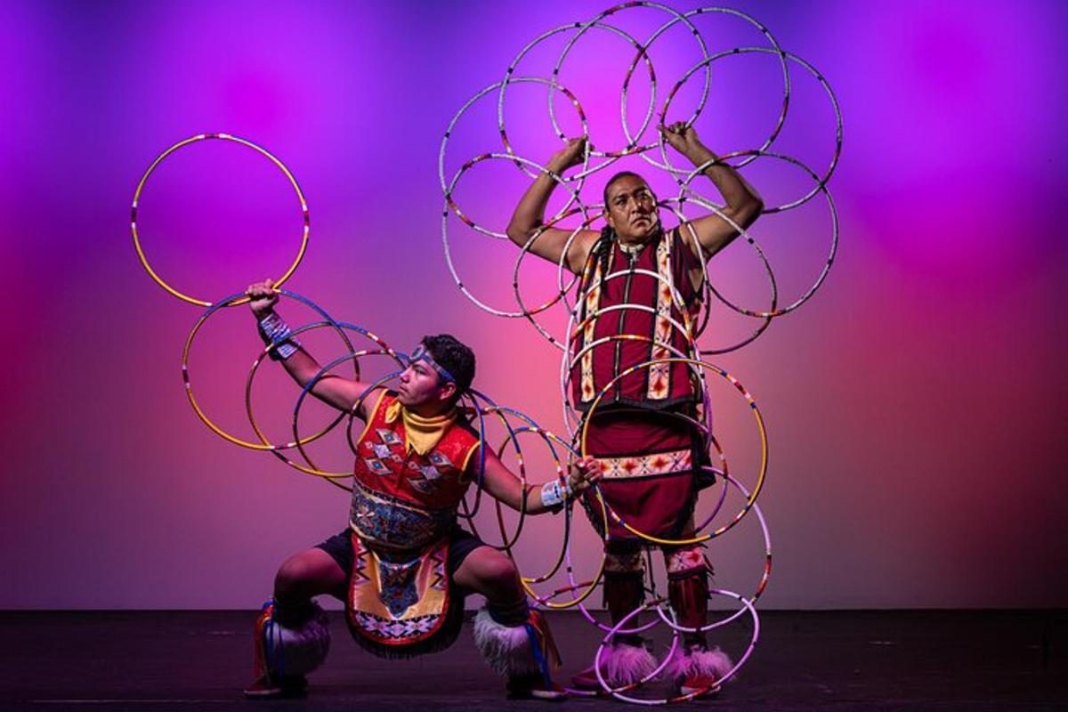 two people are playing with hula hoop