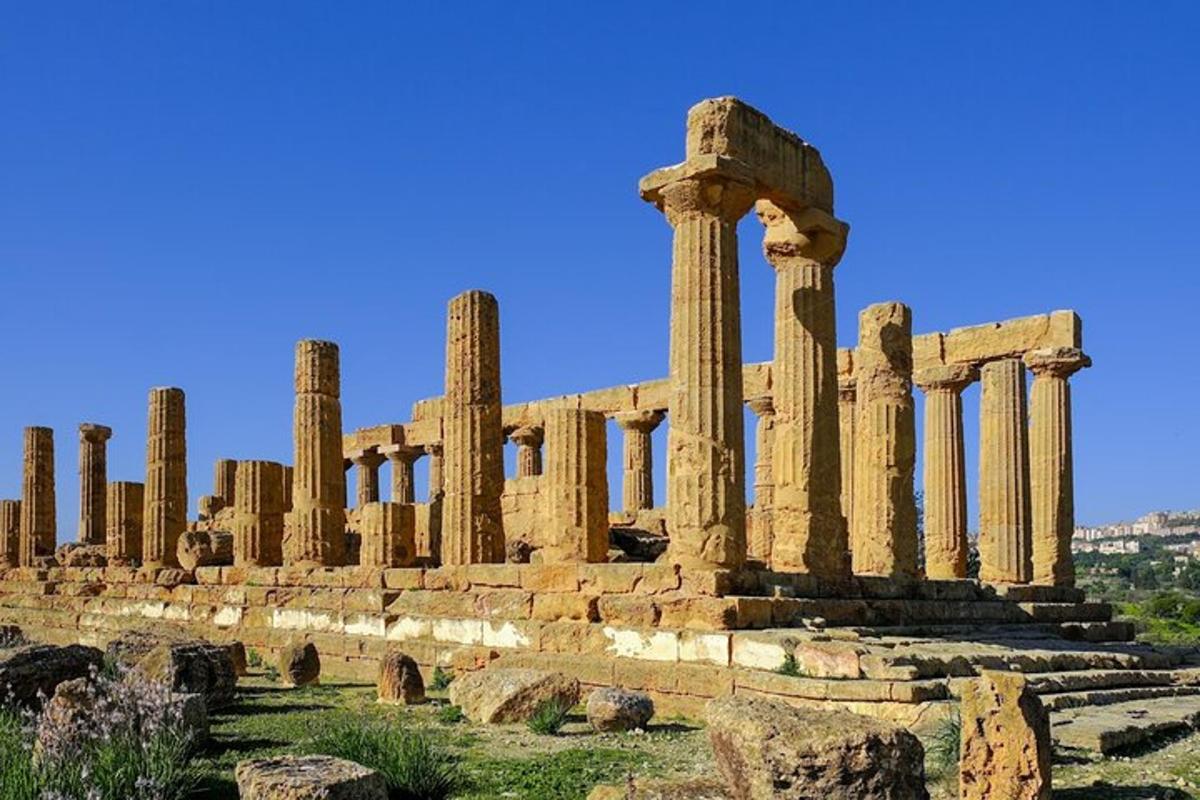 an ancient building with columns in a field