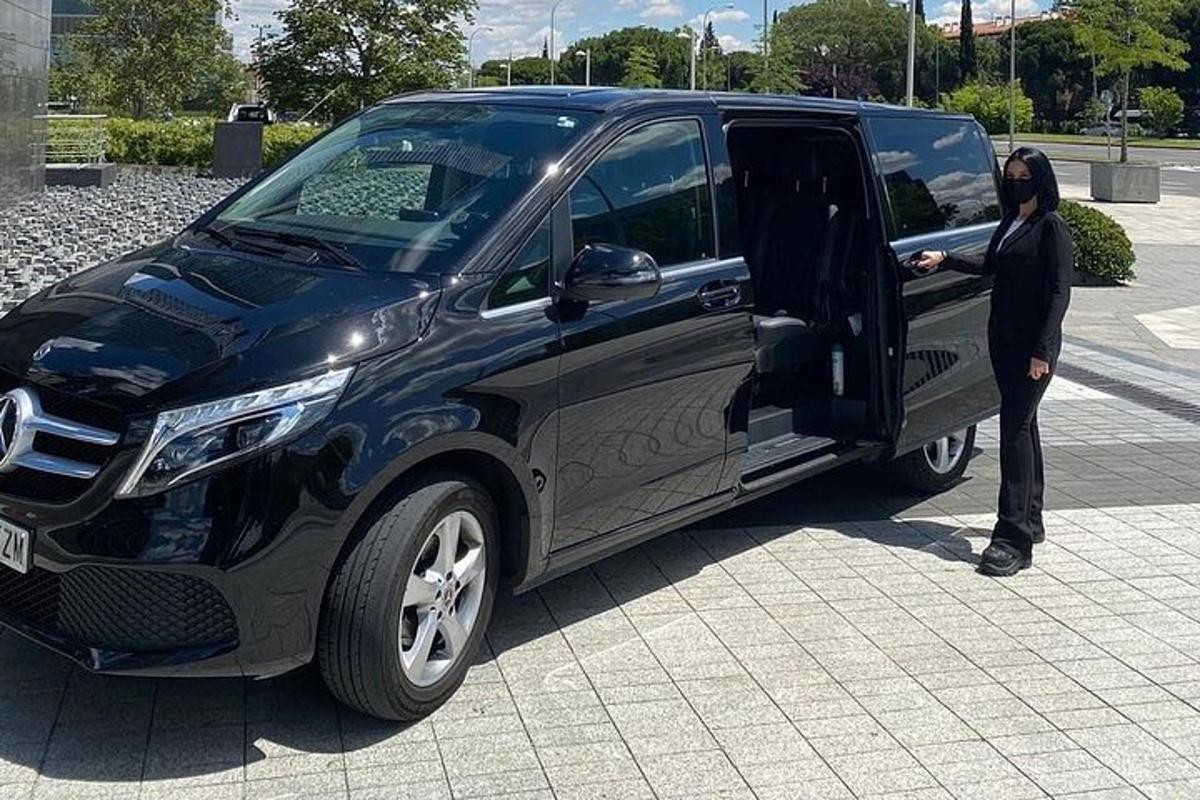 a person standing in the door of a black van