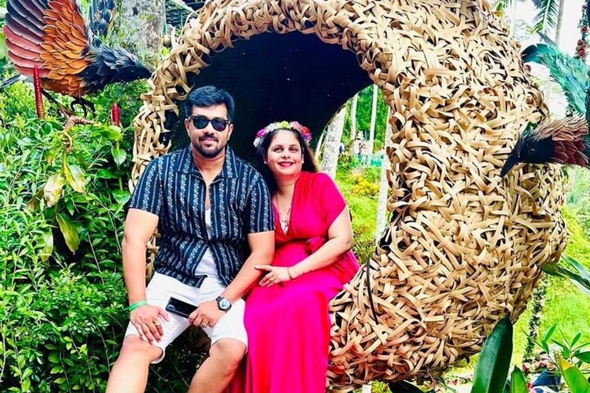 a man and a woman sitting in a wicker chair