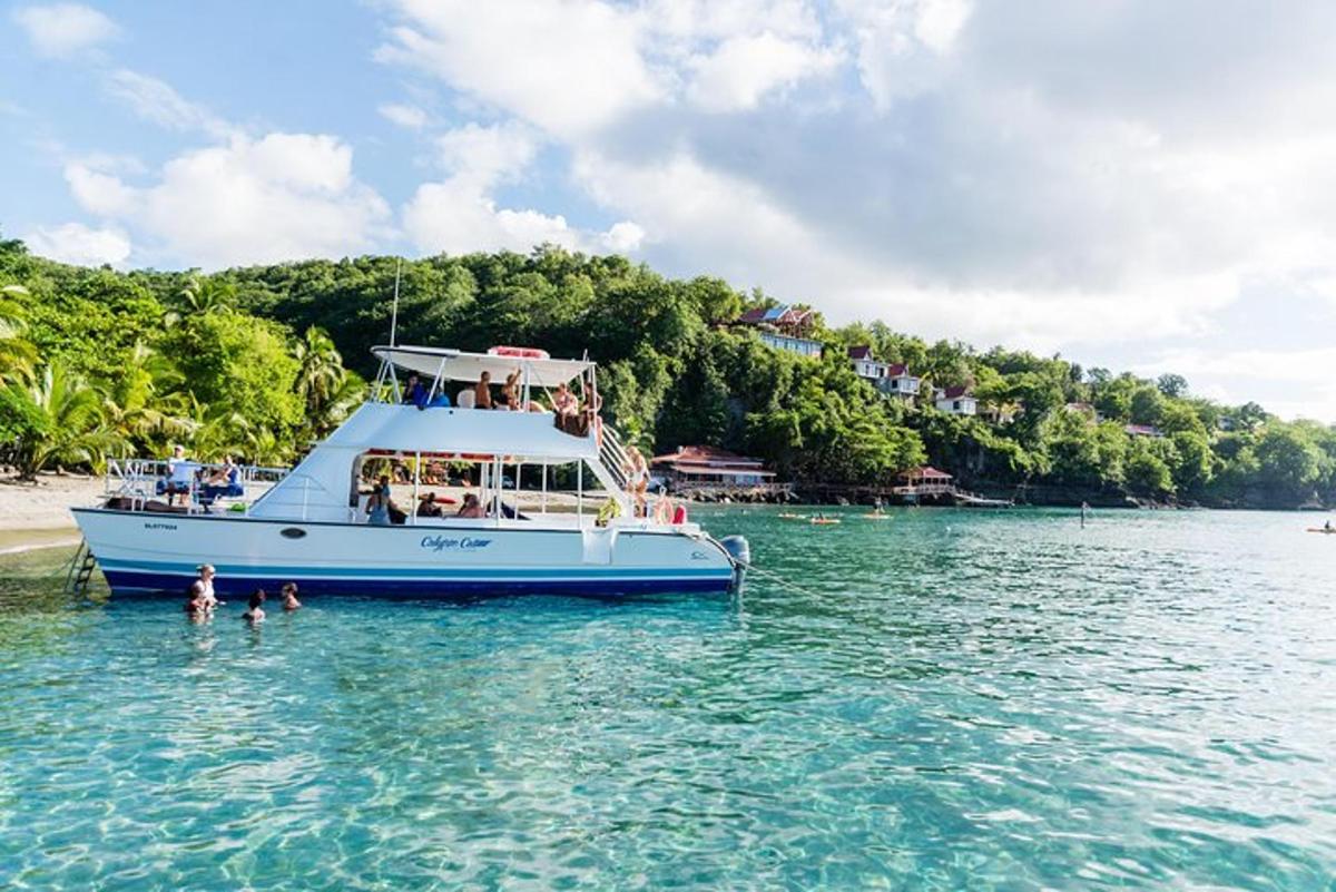 a boat in the water next to a beach