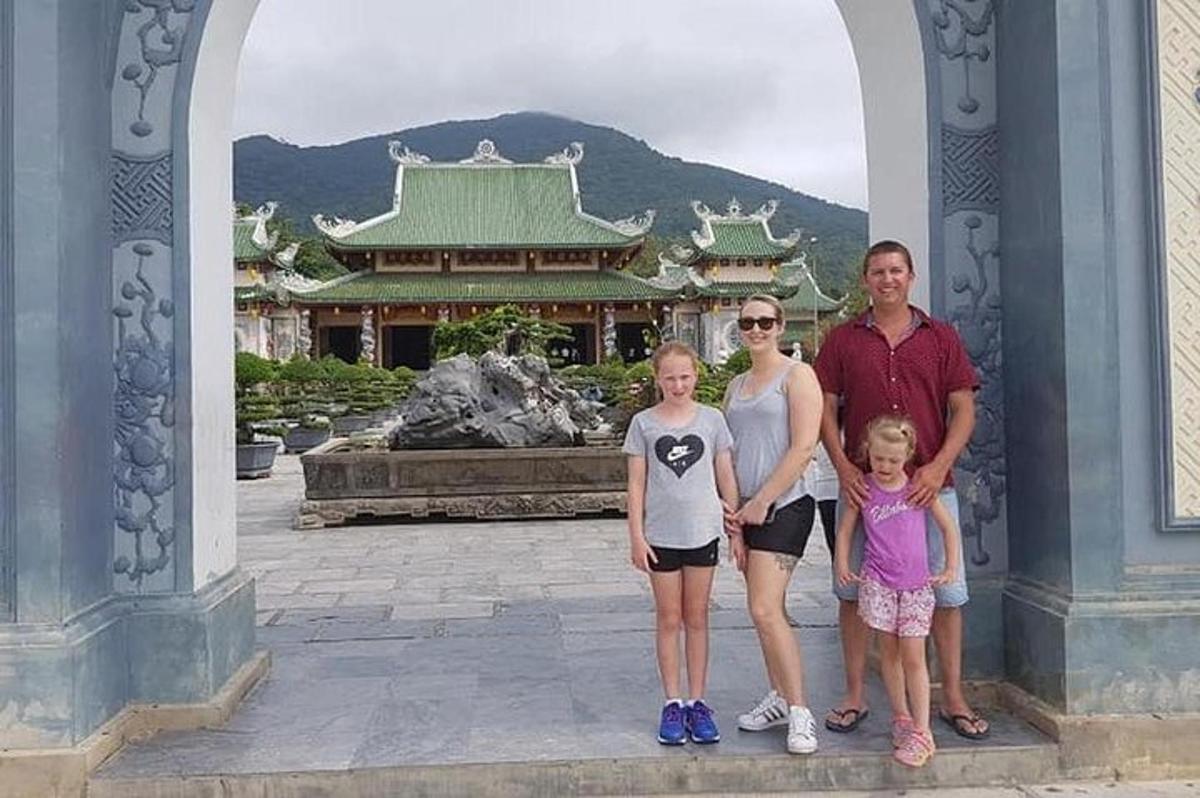 a family standing in an archway in front of a building