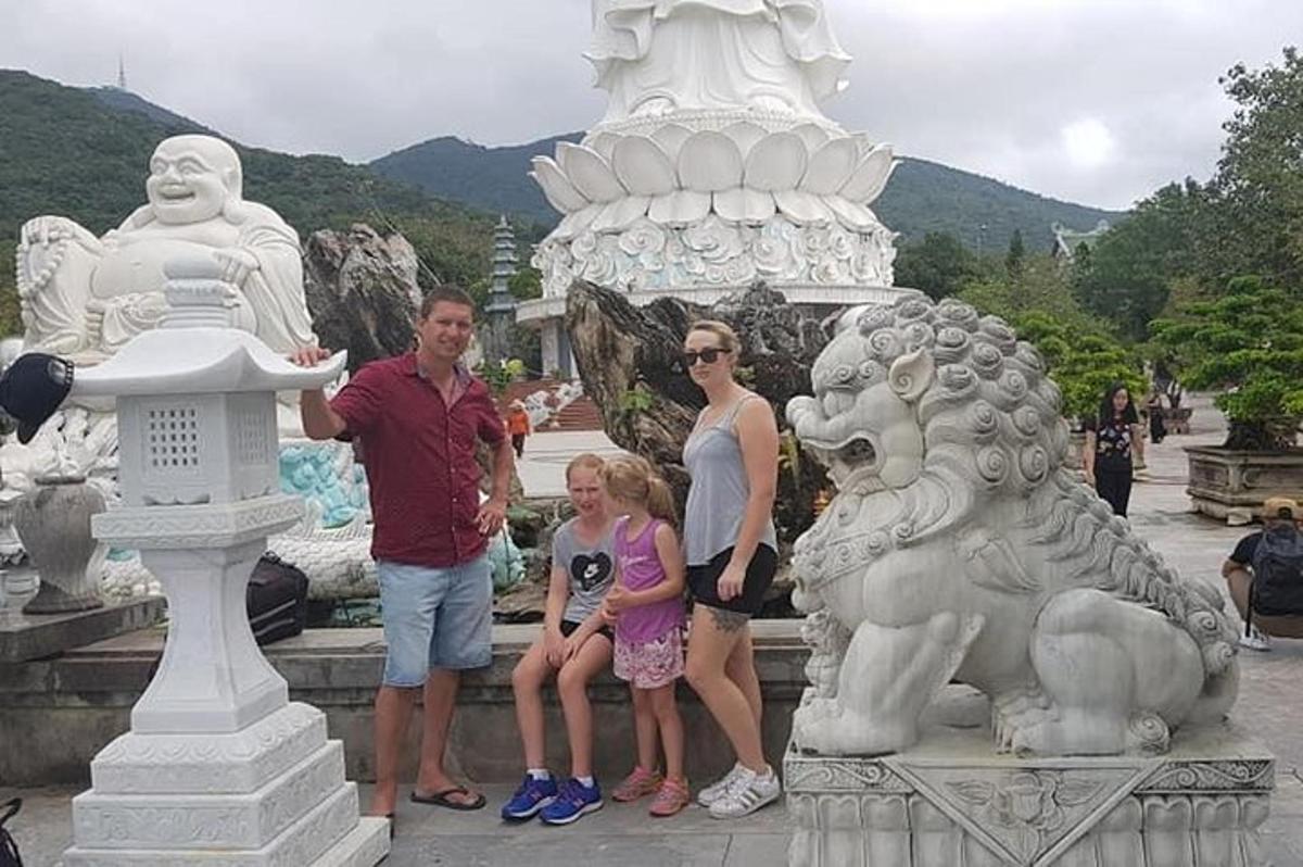a group of people standing next to a statue