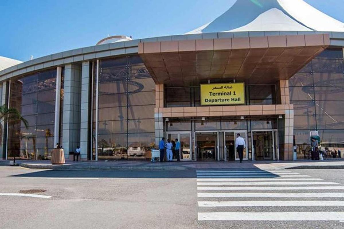 a large building with people standing outside of it