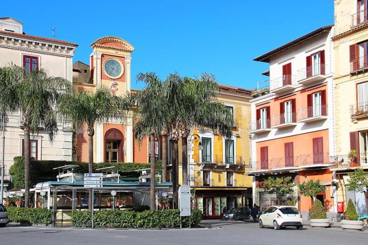 a building with a clock tower in the middle of a street