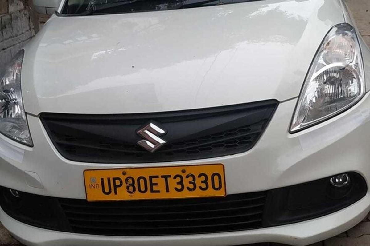 a white car with a yellow license plate on it