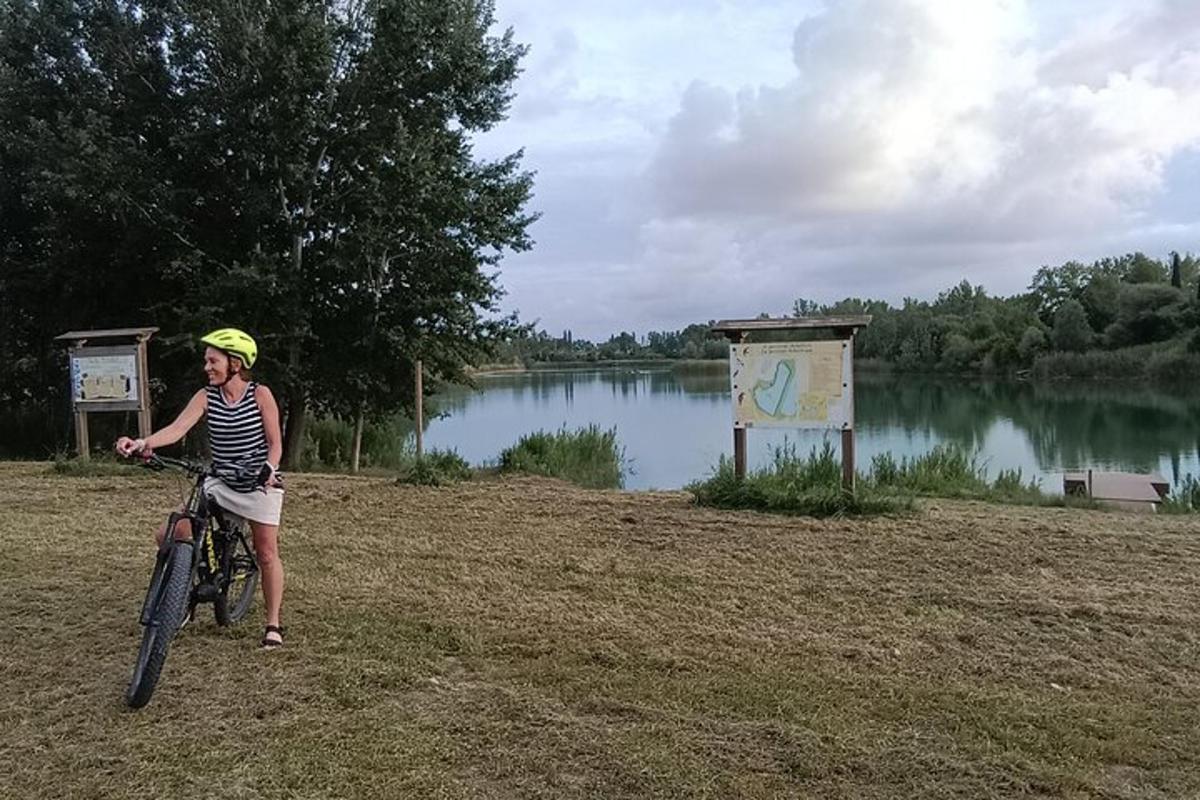kona á hjóli við hliðina á vatni