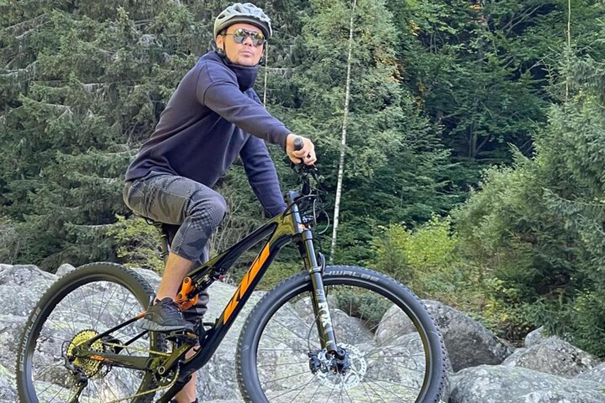 a man riding a bike on some rocks