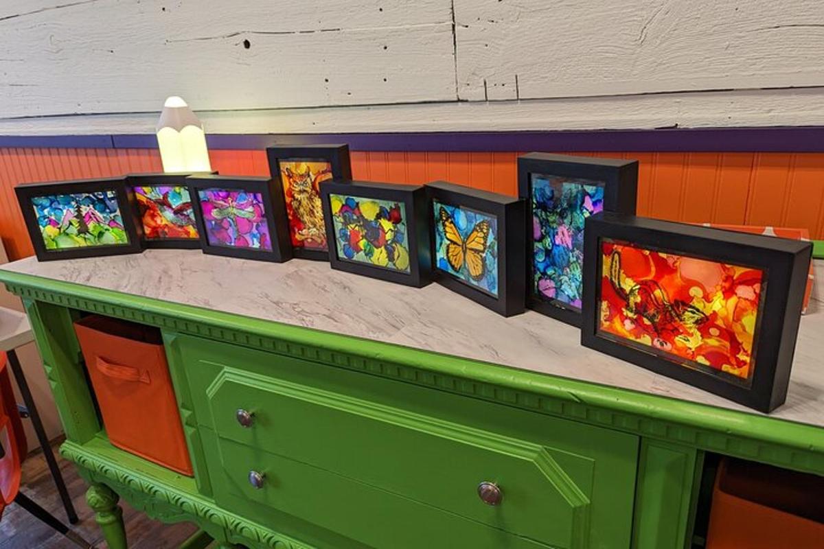a group of stained glass paintings on a counter