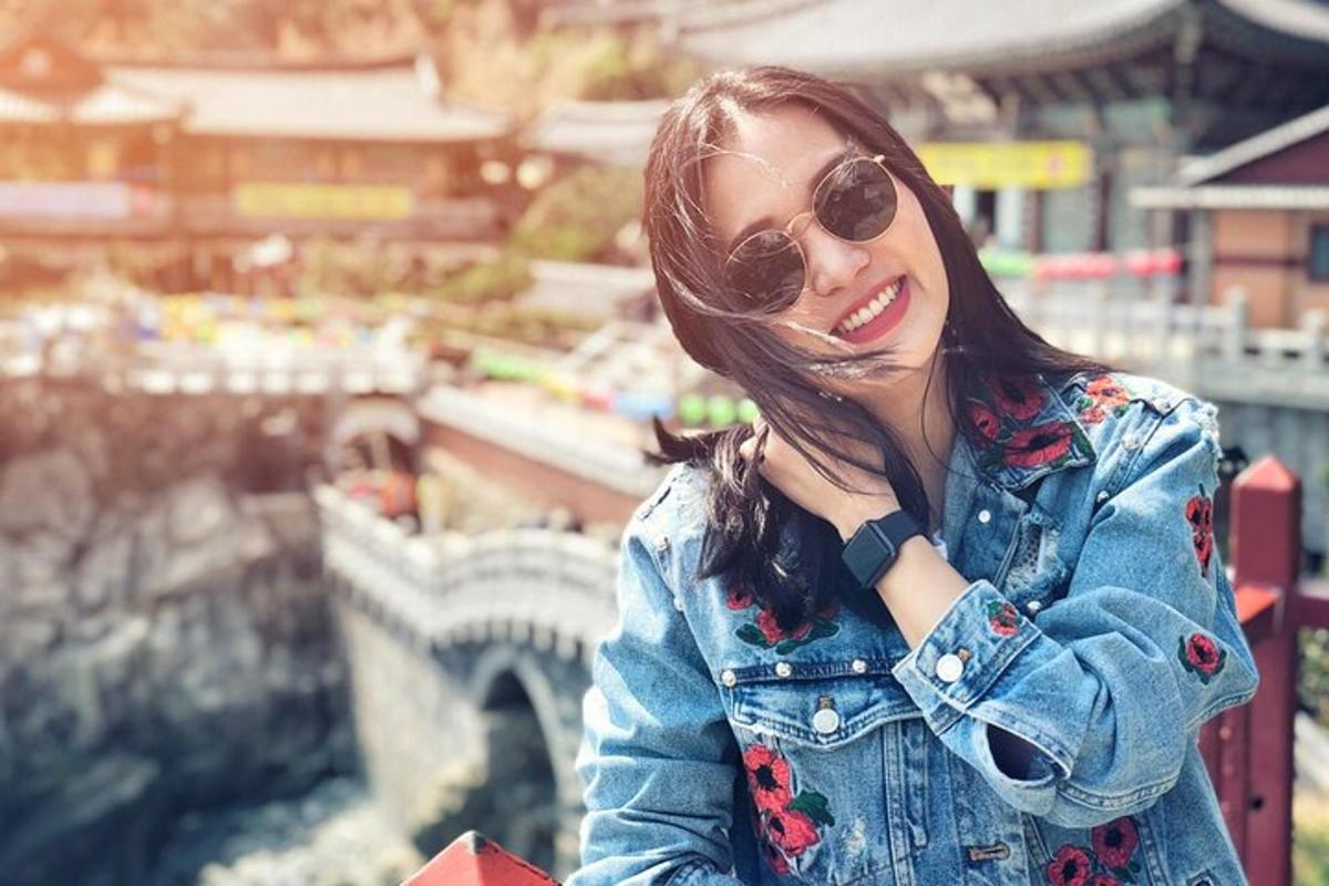 a woman wearing sunglasses and a denim jacket