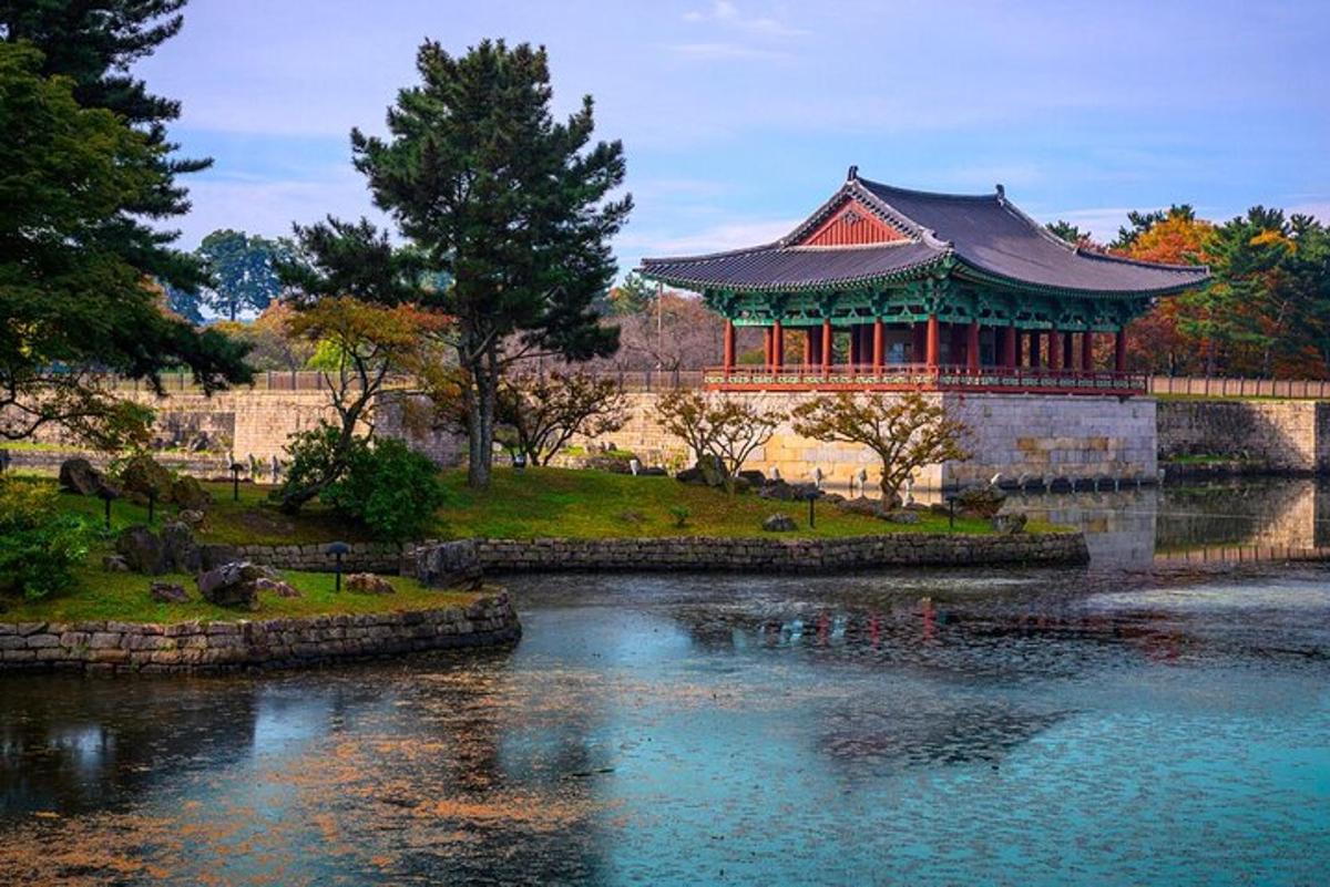 a pavilion in a park next to a river