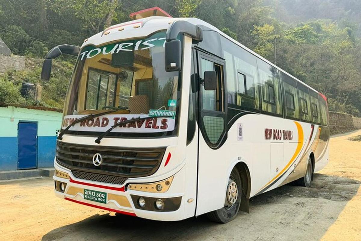 a white bus parked on a dirt road