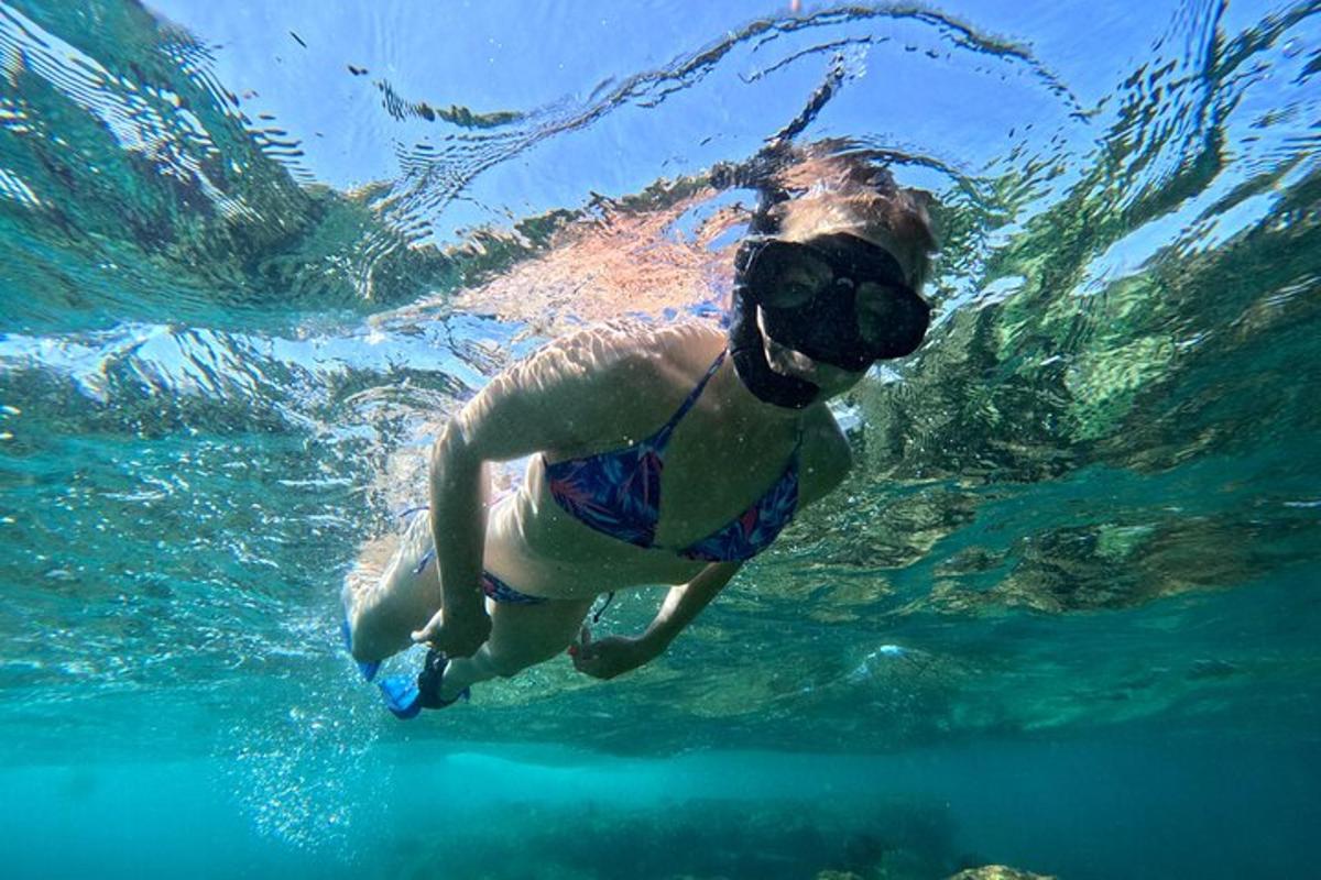 a man swimming in the water with a mask on