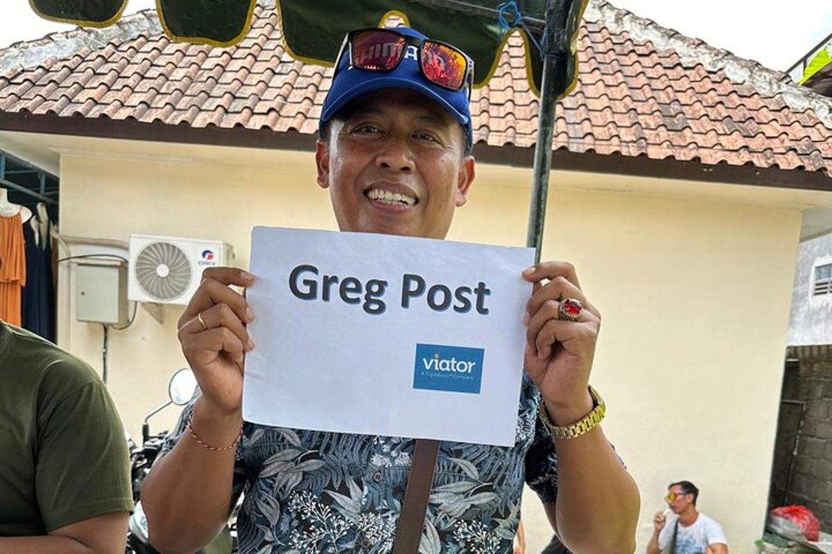 a man holding a sign that reads greep post
