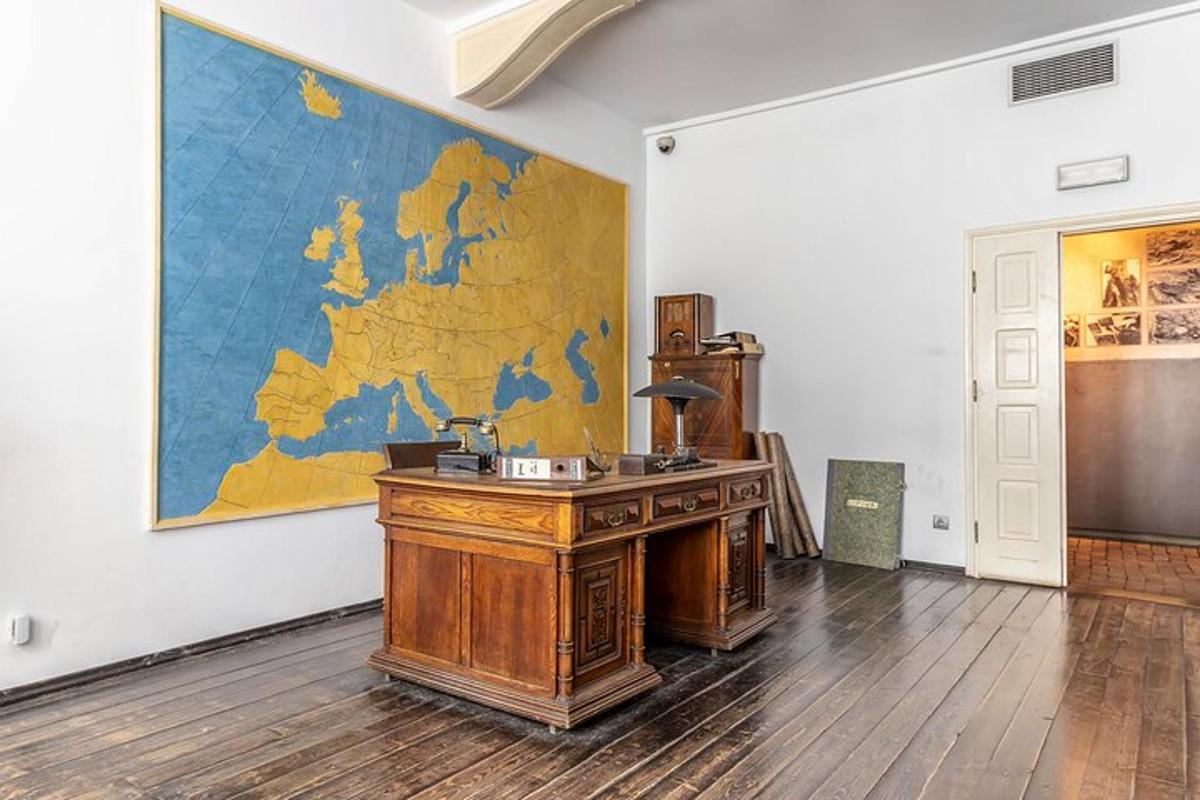 an office with a desk and a map on the wall