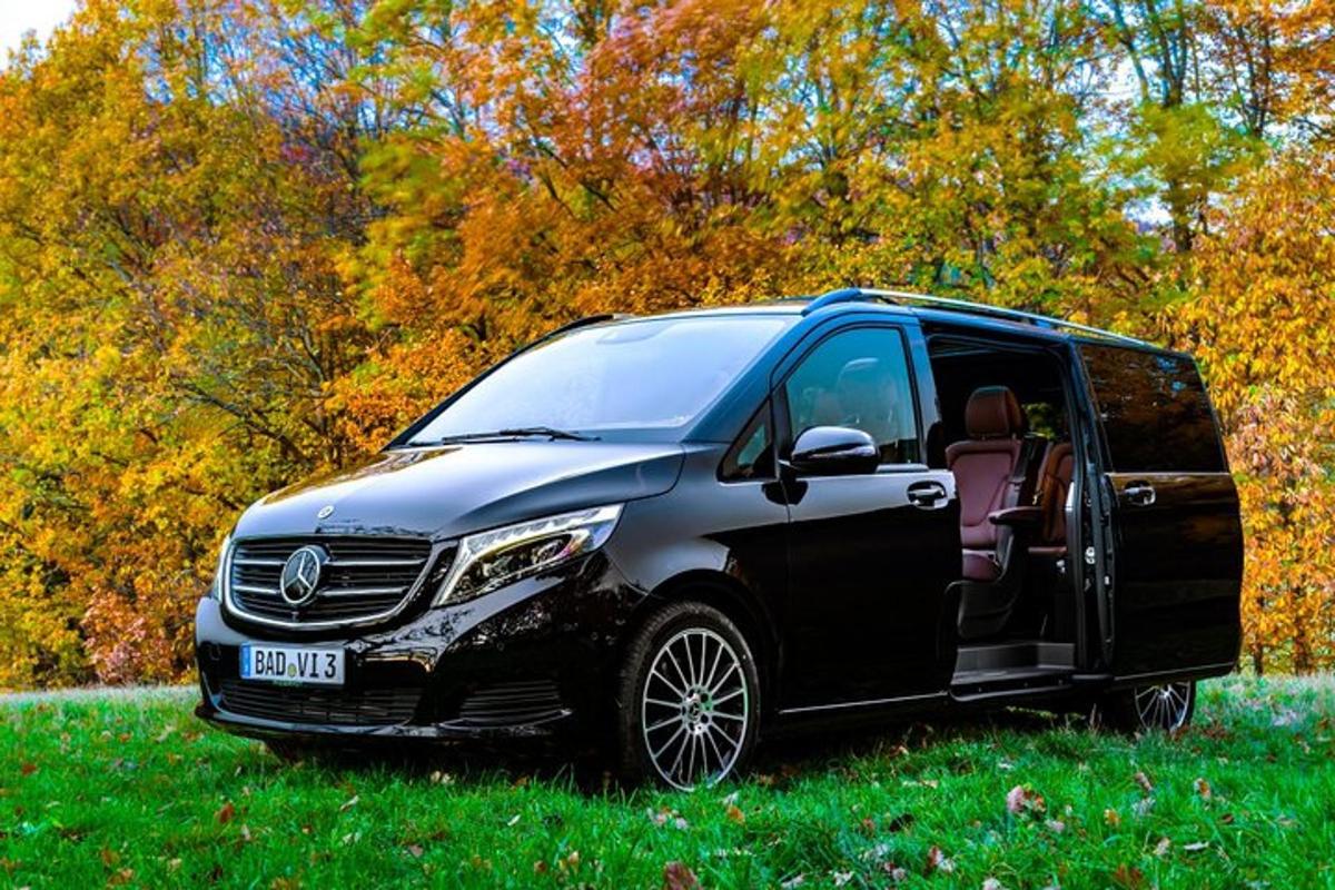 a silver and black van parked in a field