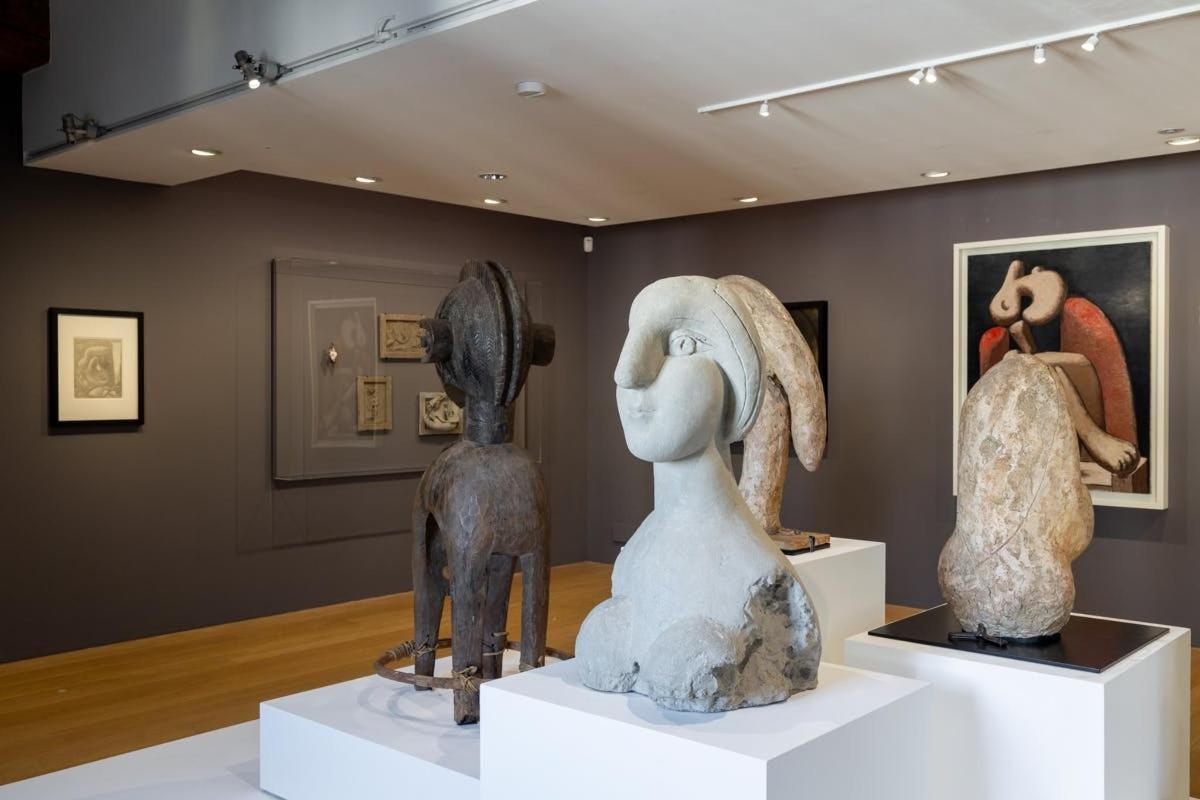 two statues on display in a museum exhibit