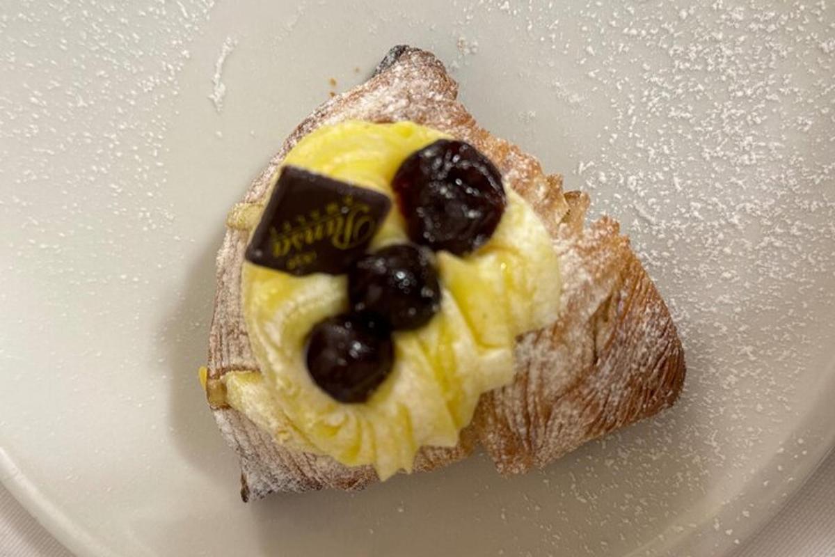 a piece of bread with fruit on top on a plate