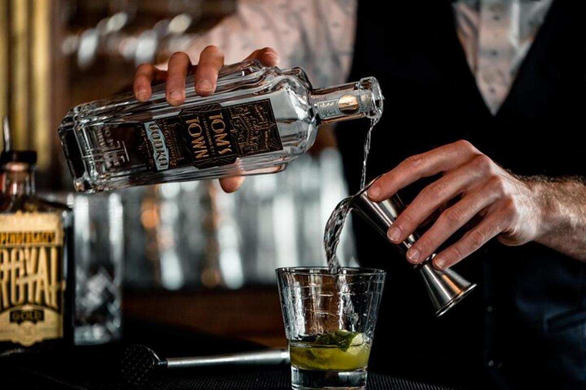 a man pouring a drink into a glass
