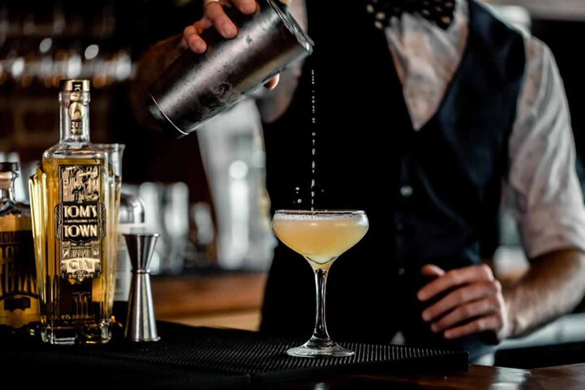 a bartender making a drink at a bar