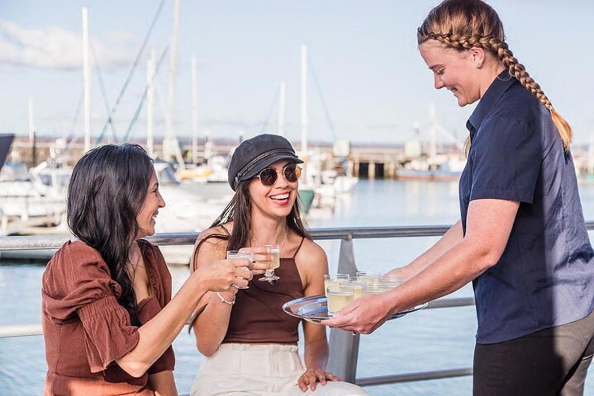 a man handing a woman a plate of wine glasses