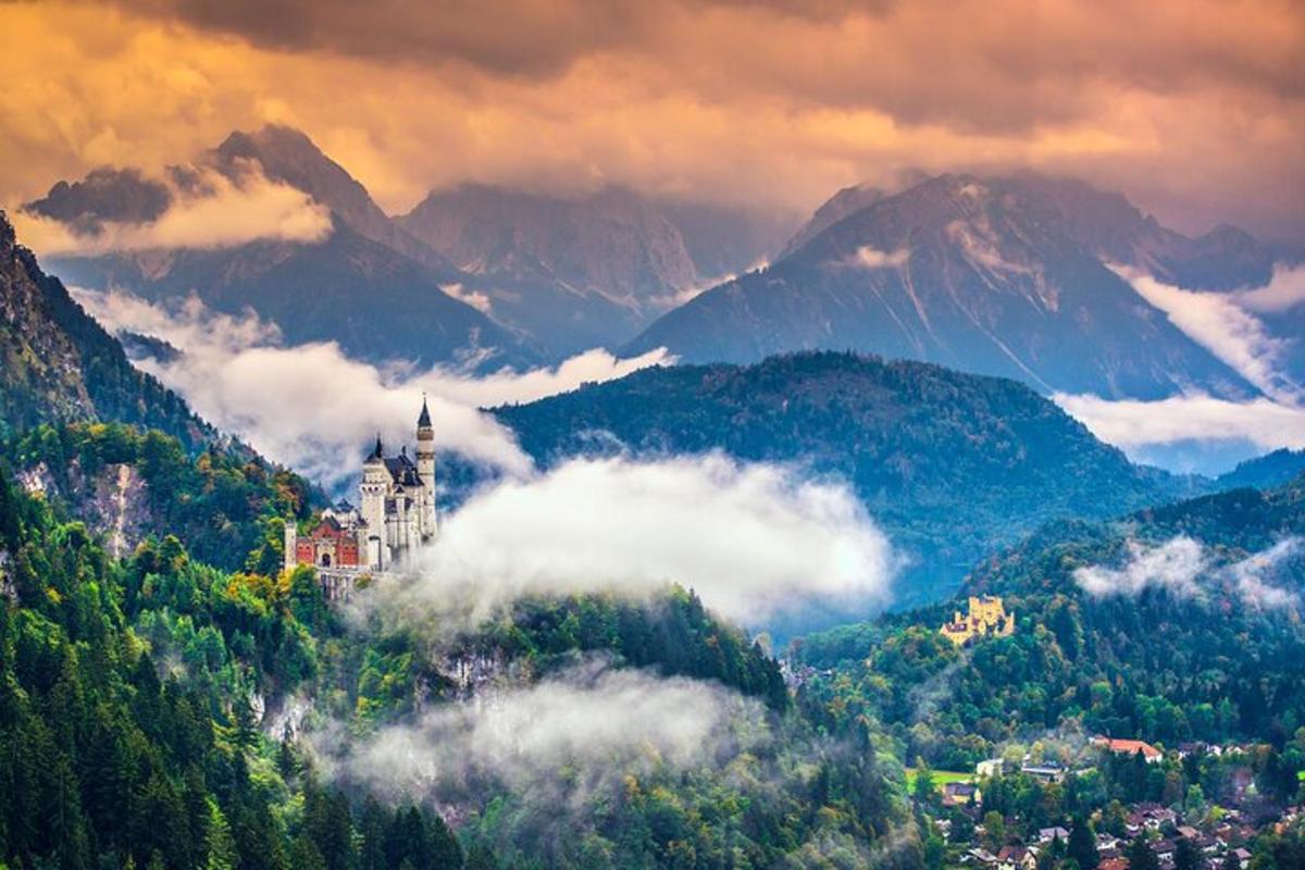 a castle on top of a hill with mountains