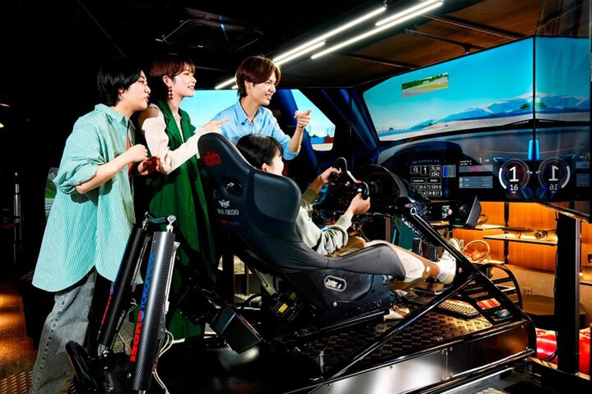 a group of people standing around a man in a car