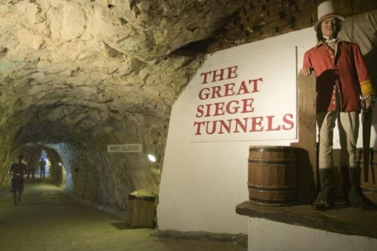 a statue of a man in a tunnel with a sign