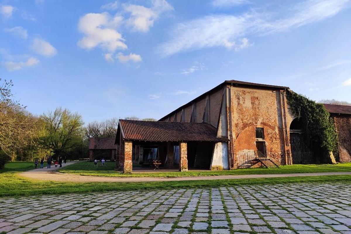an old brick building with a cobblestone street in front