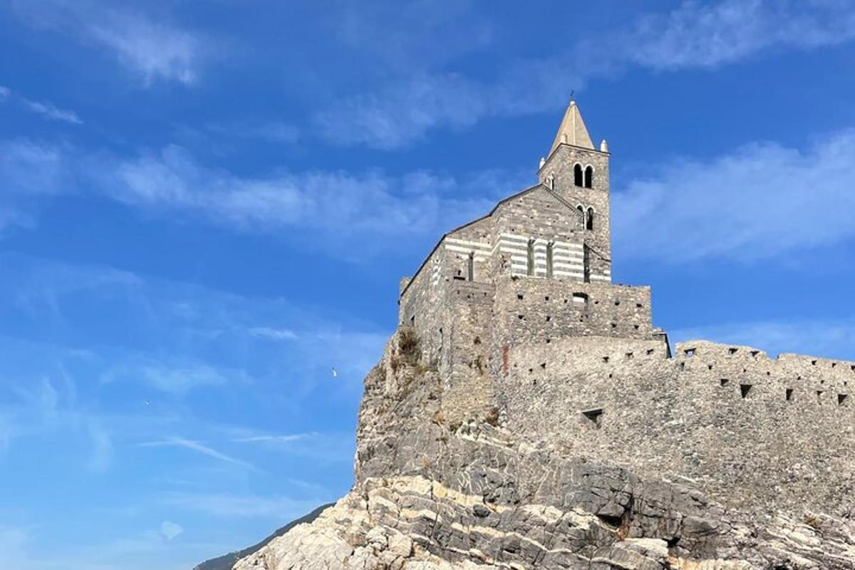 a castle on top of a mountain with a blue sky