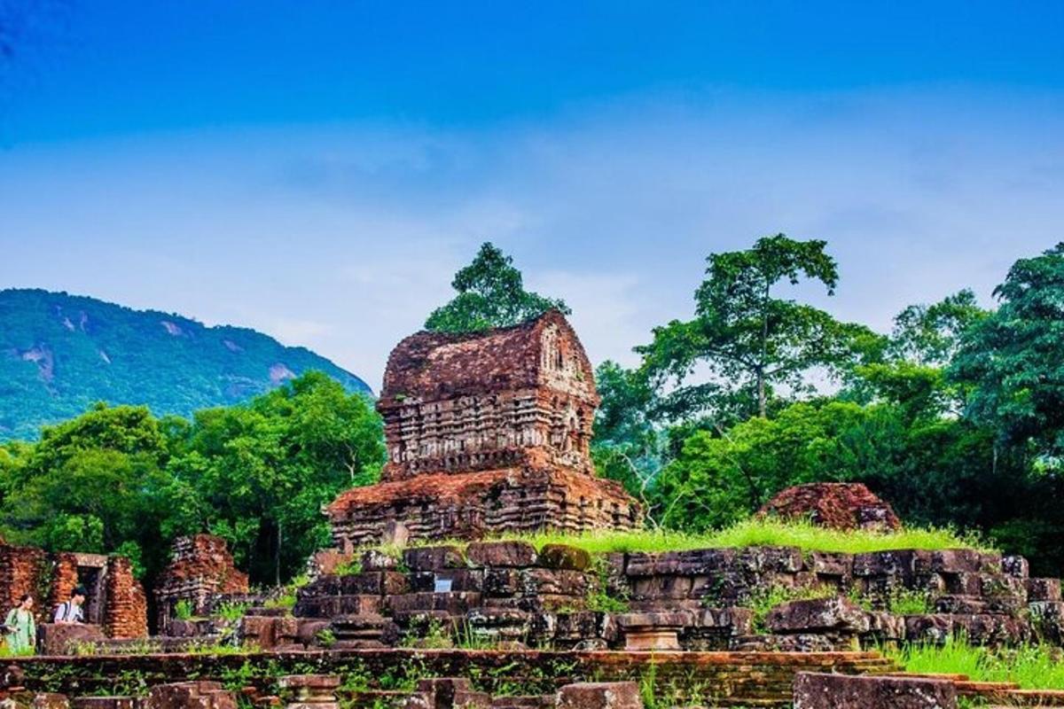 a temple in a field with trees in the background