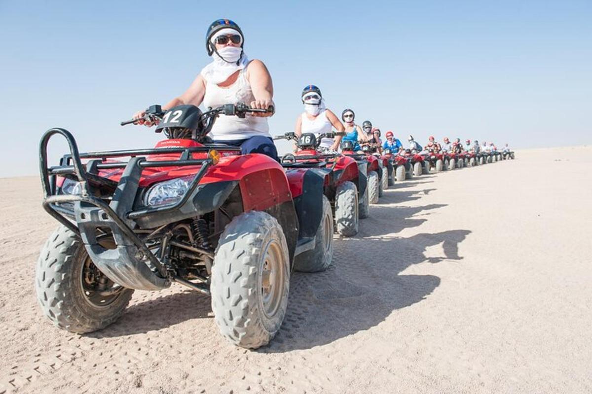 a group of men riding atvs in the desert