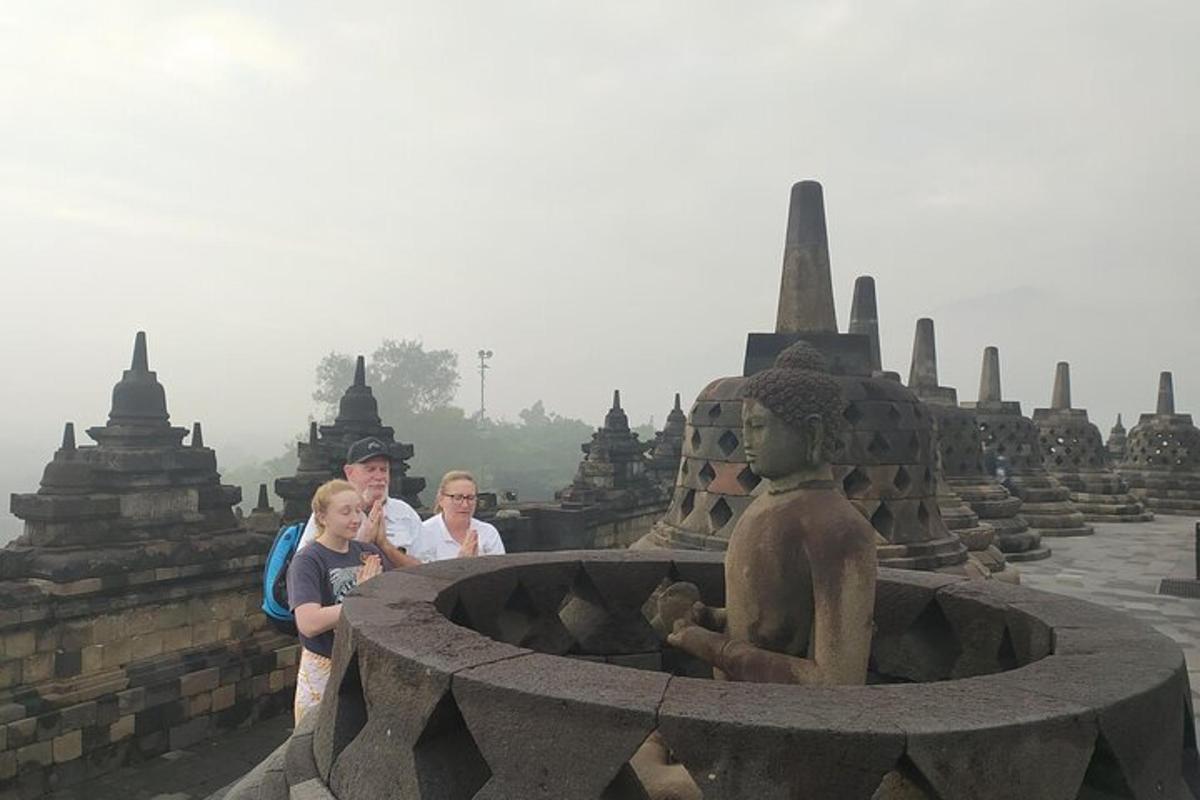 a group of people standing next to a statue