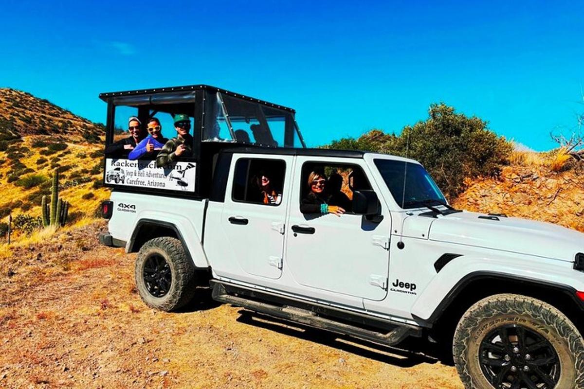 a group of people riding in the back of a white truck