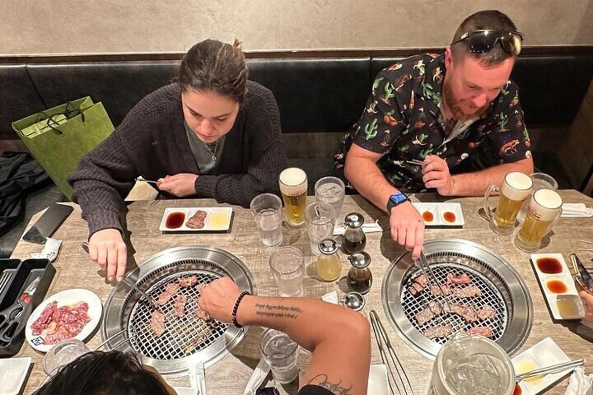 a group of people sitting at a table with food