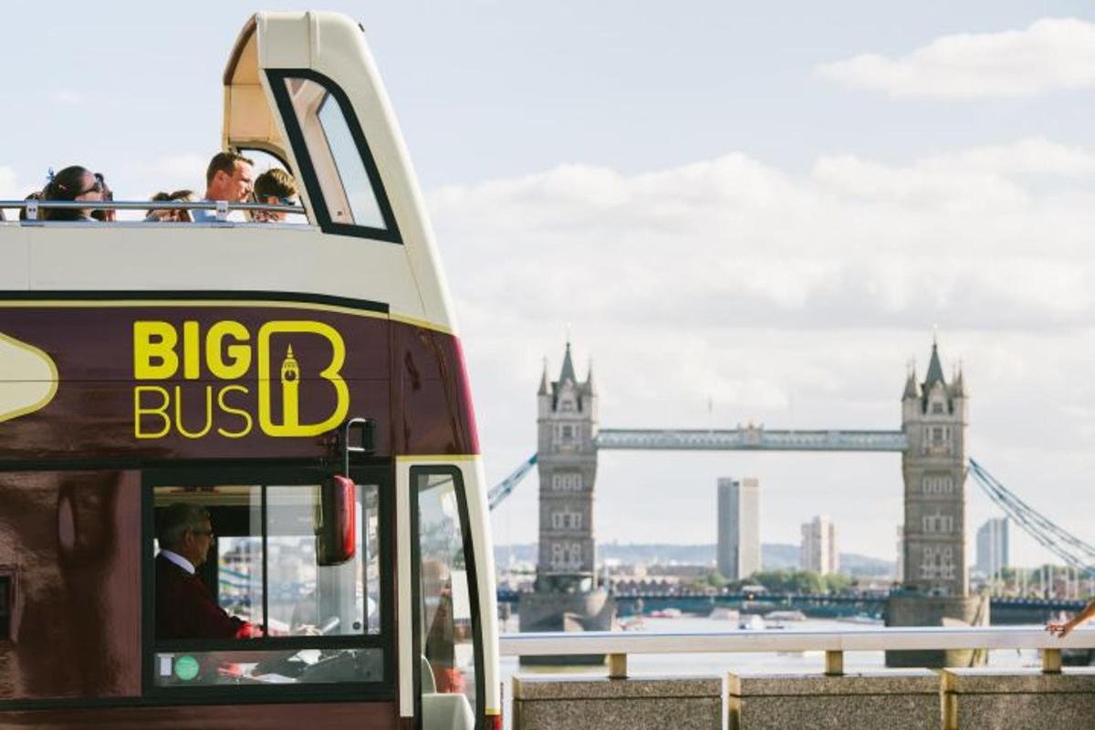 a double decker bus in front of the tower bridge