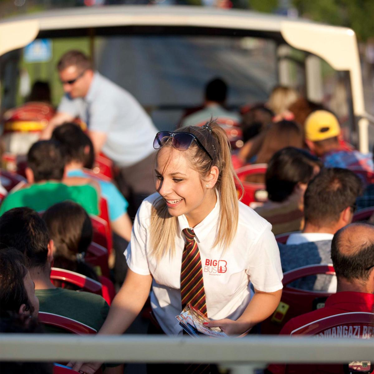 a woman wearing a tie sitting in a bus